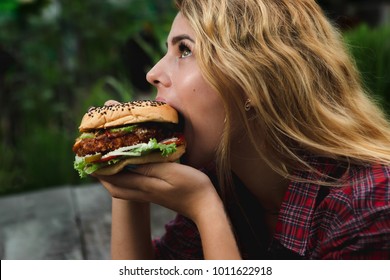 Student Consume Fast Food. Girl Bite Of Very Big Burger In The Garden 