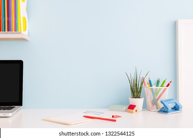 Student Creative Desk Mock Up With Colorful Office Supplies, Laptop And Blue Wall. Back To School.