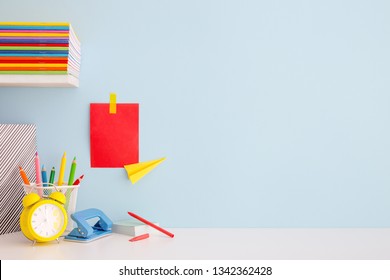 Student Creative Desk Mock Up With Colorful Office Supplies, Laptop And Blue Wall. Back To School.