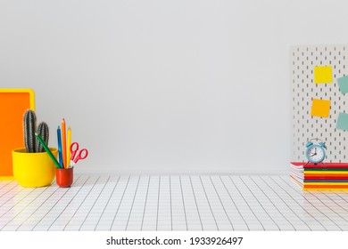 Student creative desk mock up with colorful office supplies, laptop and blue wall. Back to school. - Shutterstock ID 1933926497