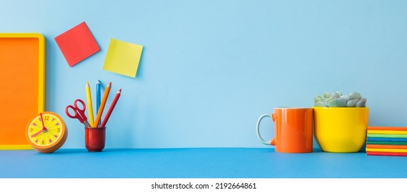 Student creative desk mock up with colorful office supplies, notebooks, notes, crayons and blue wall background. Back to school. - Powered by Shutterstock