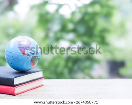Student creative desktop, Earth globe on hardcover book. Copy space for text, Back to school, Education concept