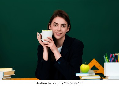 Student with cup drinking tea in classroom. Coffee break in university. Student girl in high school classroom. Knowledge in high school. Schoolgirl in high school or university.