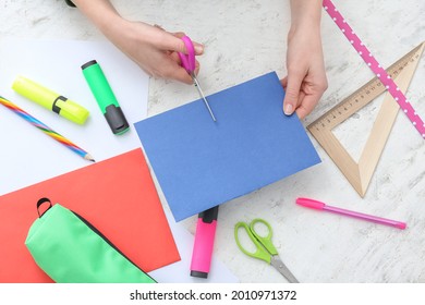 Student Cutting Paper Sheet At Table