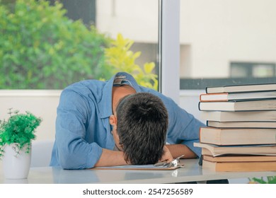 student at desk with stressed or overwhelmed books - Powered by Shutterstock