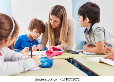 Student doing homework Mentoring in elementary school with a teacher