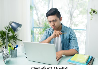 Student Doing Homework And Preparing Exam At Home.