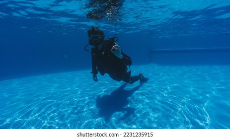 student doing scuba diving classes learning hover and buoyancy - Shutterstock ID 2231235915