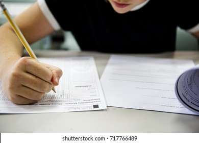 Student doing the test exam - Shutterstock ID 717766489