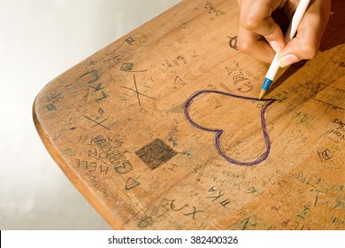 Student Drawing A Heart On Her Desk