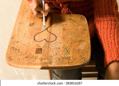 Student Drawing A Heart On Her Desk