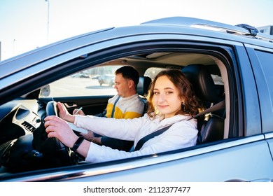 A Student Driver With Her Driving Instructor