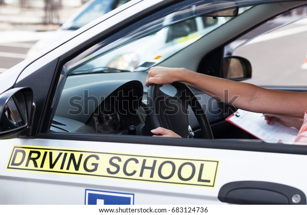Student\
driver. Learning to drive a car. Driving\
school.