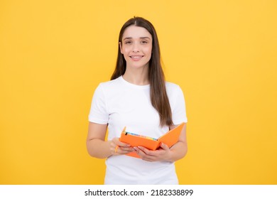 Student education in high school university college concept. Happy young girl holding note book. Smart looking girl student on yellow background.