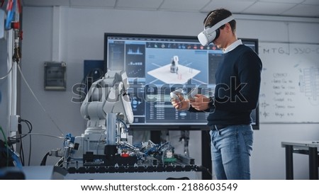 Student Engineer Using Virtual Reality Software for His Project. Man with Headset and Controllers Studying at Modern University in Classroom. Futuristic and High Tech Concept