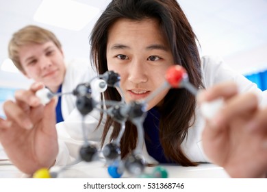 Student examining molecular model - Powered by Shutterstock