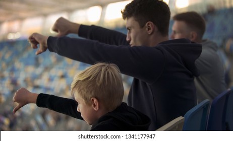 Student Fans And Little Boy Booing Sport Game At Stadium, Watching Junior Match