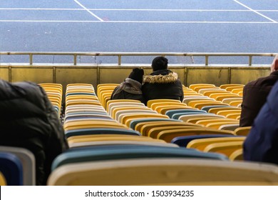 Student Fans And Little Boy Booing Sport Game At Stadium, Watching Junior Match