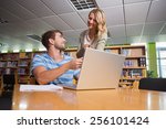 Student getting help from tutor in library at the university
