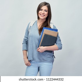 Student girl with backpack holding exercise notebook. Smiling woman isolated portrait.