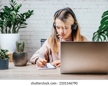 Student Girl In Headphones Watching Online Video Zoom Class Webinar In Virtural Classroom On Her Laptop