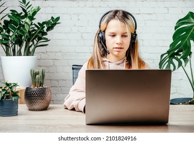 Student Girl In Headphones Watching Online Video Zoom Class Webinar In Virtural Classroom On Her Laptop