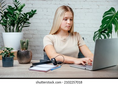 Student Girl In Headphones Watching Online Video Zoom Class Webinar In Virtural Classroom On Her Laptop