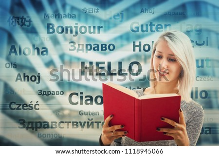 Student girl holding a dictionary and word hello translated in different languages on the background. Young school teacher learning and speaking many languages. International communication concept.