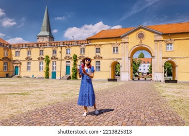 Student Girl With Laptop And Drinking Coffee, Going To The Entrance To The Campus Or Faculty Of Some Old University. Education In Europe Concept