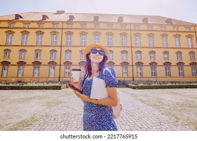 Student Girl With Laptop And Drinking Coffee, Going To The Entrance To The Campus Or Faculty Of Some Old University. Education In Europe Concept