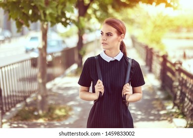 Student Girl Outdoors Walking On Sidewalk Going Back To School – College Woman With Backpack And Uniform Smiling – Education Concept With Trendy Teenage Female On Her Way To First Day At University