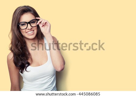 student girl in white shirt and glasses on yellow background