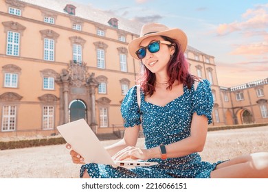 Student Girl Is Working And Studying At A Laptop Sitting At The Entrance To The Campus Or Faculty Of The Old European University