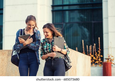 Student Girls Having A Small Talk. After Class Fun Time. Back To School Concept.