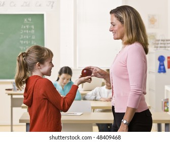 Student Giving Teacher Apple