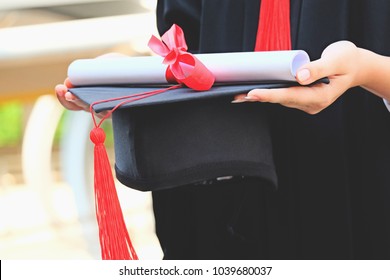 Student In Graduation Cap With Certificate In Hand