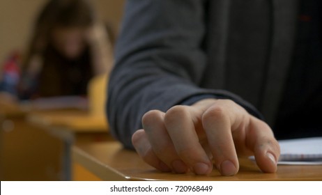 Student Hand Finger Tapping Closeup. Young Man Taps His Fingers On A Table