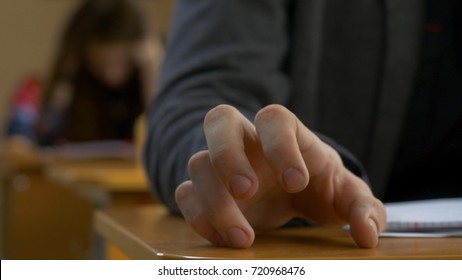 Student Hand Finger Tapping Closeup. Young Man Taps His Fingers On A Table