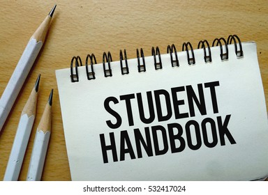 Student Handbook Text Written On A Notebook With Pencils