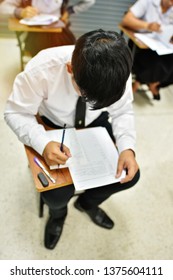 Student Having Test In The Room At The Test Center - Educational Concept Of Students In The Lecture Hall, Or Learning Center At The Collage Or University Campus, Selective Focus  On Top Of The Head