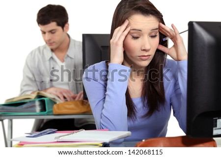 Student with a headache at a computer