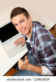 Student With Laptop Showing Thumb Up