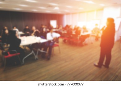 Student listening to a lecture or presentation in class seated in the front row of the audience with selective focus to the back of the head