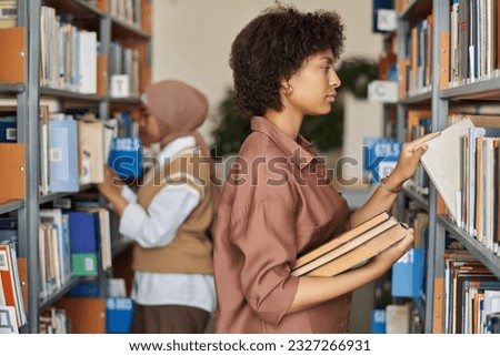 Student looking for books to study in the library