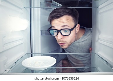 Student Looking Inside An Empty Refrigerator