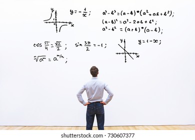 student looking at mathematical formulas, learn maths education concept