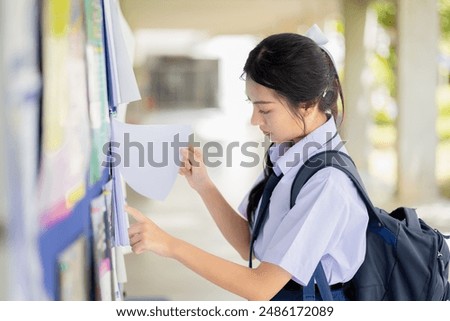 Student looking message at school billboard to study information announcement, School teen seeking part time jobs.