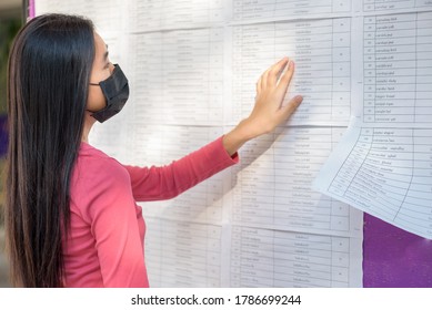 Student Is Looking For A Name From The Exam Results On The Board. At University ,Back To School Concept.