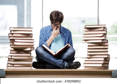 Student With Lots Of Books Preparing For Exams