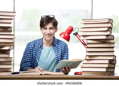 Student With Lots Of Books Preparing For Exams